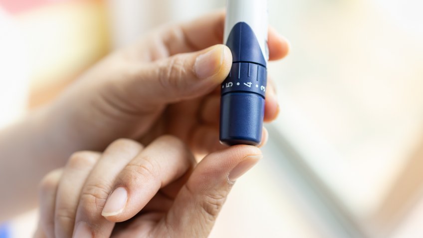 diabetic patient using glucose testing equipment