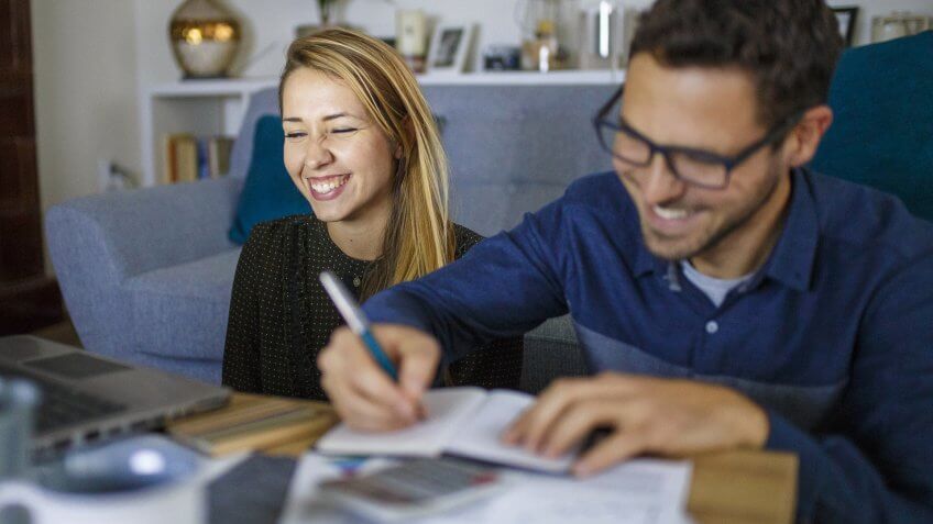 Couple at home sorting through bills and taxes.