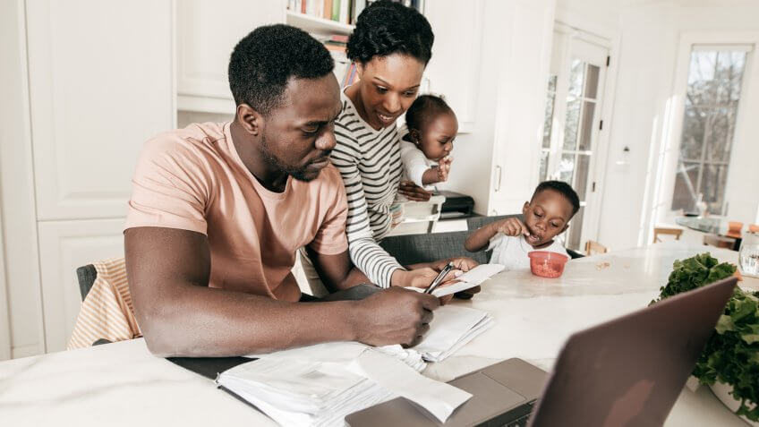 A couple is making a list of the debts they need to settle.