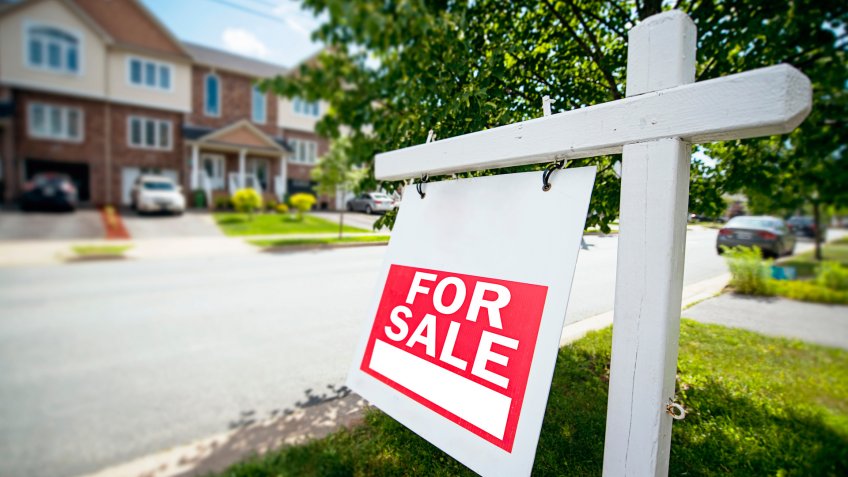 for sale sign in front yard