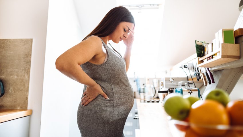 pregnant woman have a pain standing.