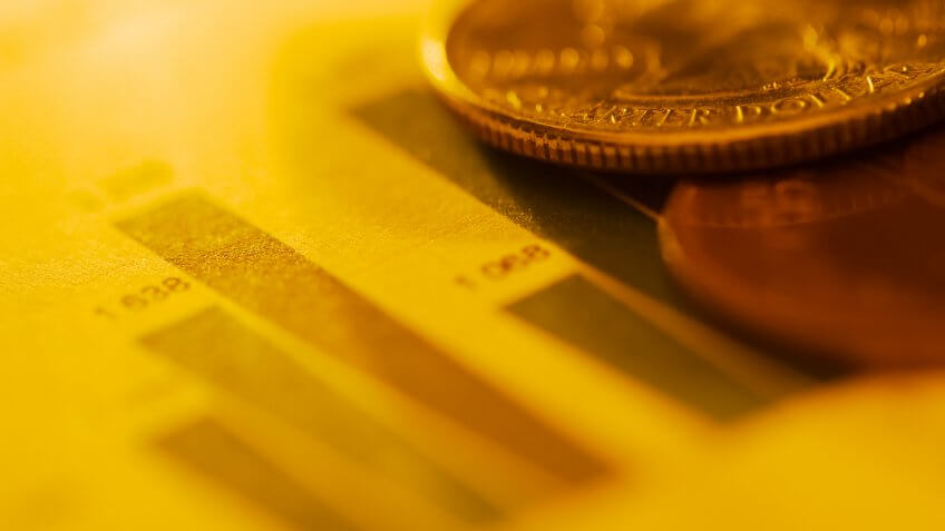 Coins on financial diagram.