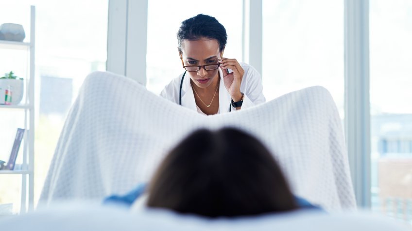 Shot of a young woman having a consultation with a gynaecologist.