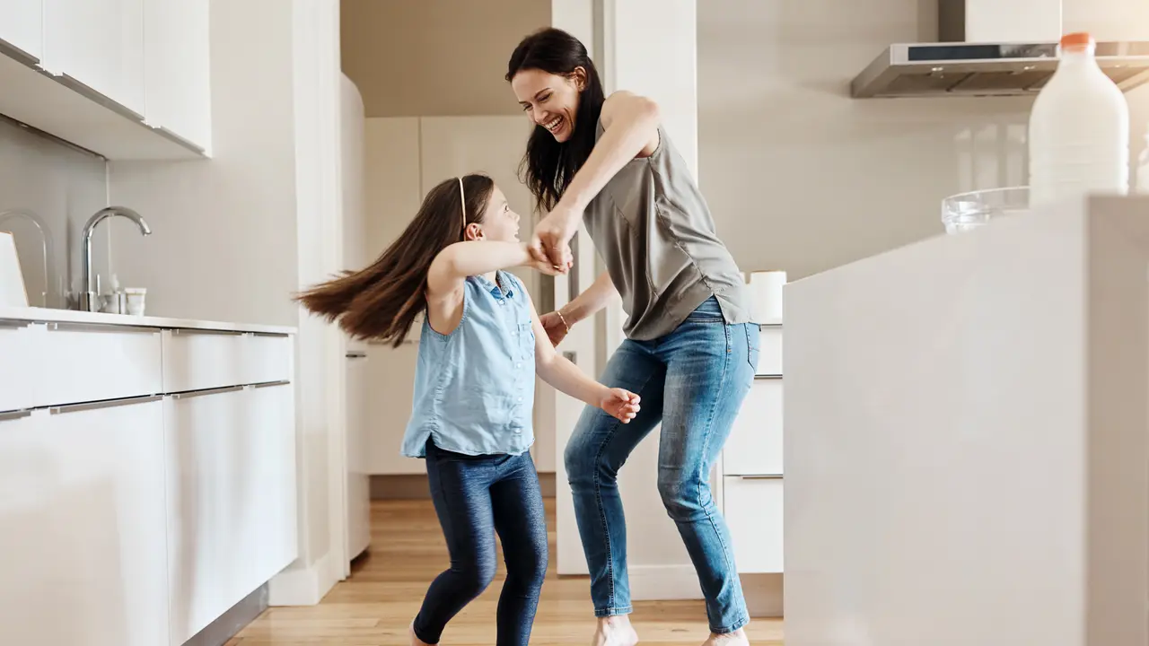 Shot of an adorable little girl dancing with her mother at home.