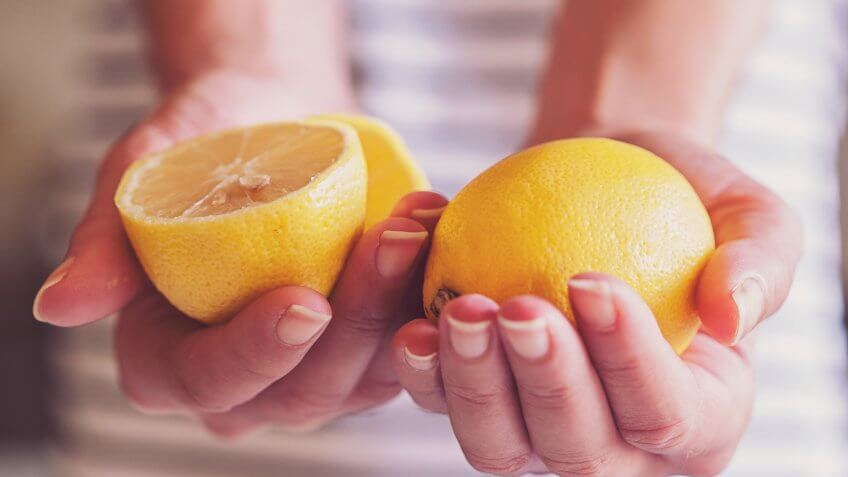 woman holding lemons.