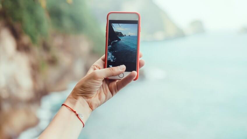 influencer taking photo on smartphone