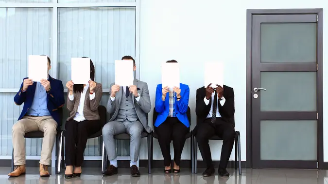 Human resource concept, Young businessman holding white billboard and waiting for job interview.