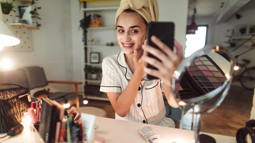 Young woman in her apartment doing her beauty care routine.