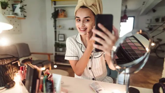 Young woman in her apartment doing her beauty care routine.