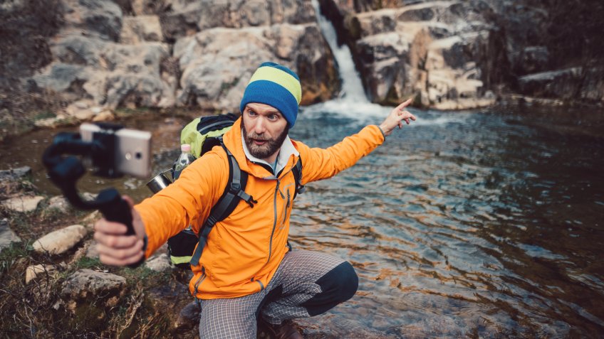 Young man in the mountain vlogging.