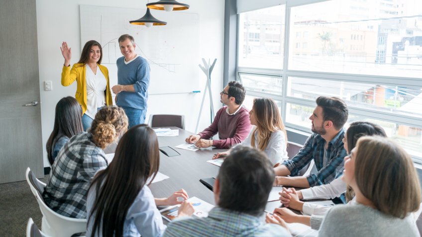 Group of people in a business meeting at the office introducing a new member of the team.