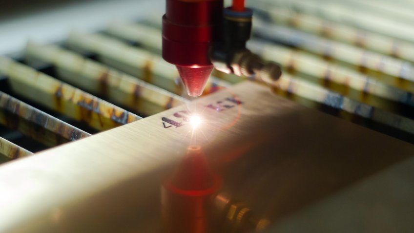 stage of manufacturing, laser engraving in automatic mode, close-up, blurred background.