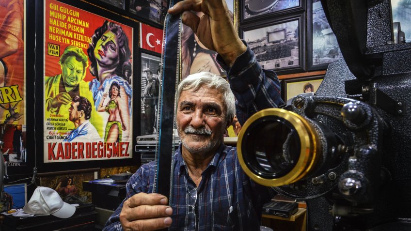 ADANA,TURKEY-MARCH 21: Movie Projectionist inspecting film before show the movie.
