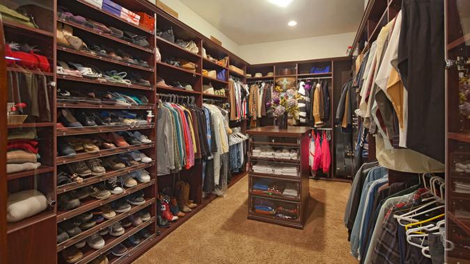 Walk in closet with organized clothing.