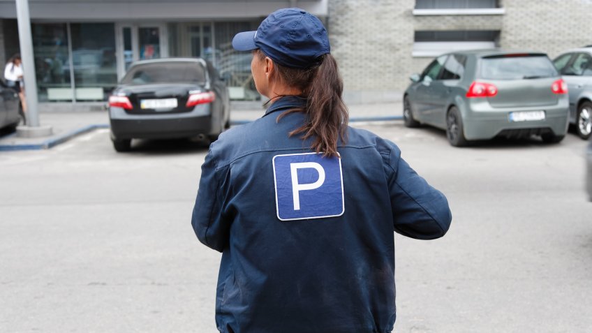 The girl in the form of a parking attendant in the city - Image.