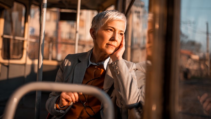 Stressful business woman riding tram.