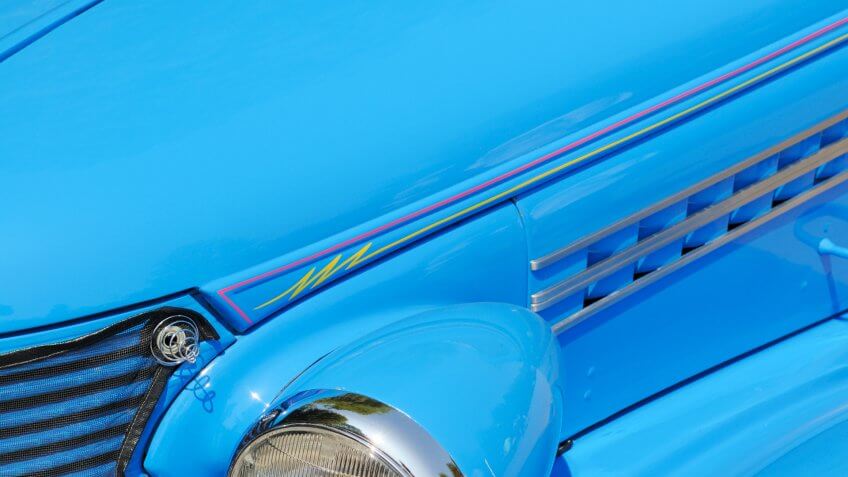 A pre-1949 classic streetrod with blue paint and pinstriping paint job.