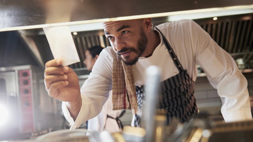 Shot of a chef looking at an order in the kitchenhttp://195.