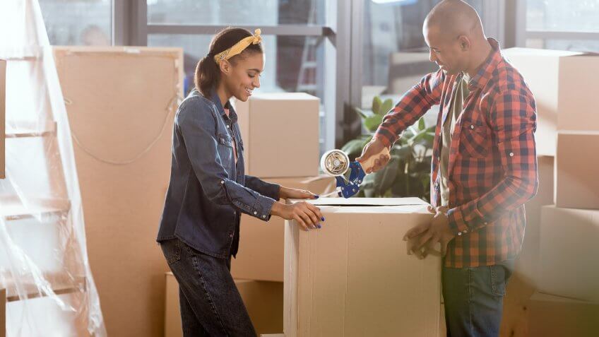 two people packing boxes