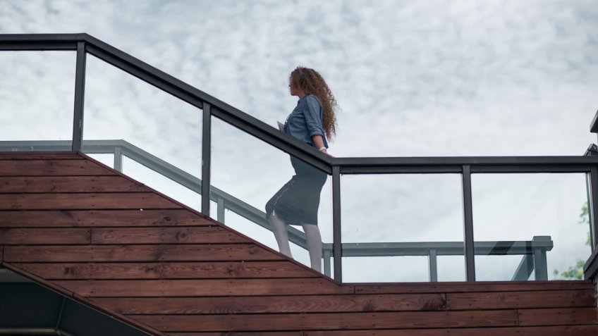 Shoot of businesswoman on top of the steps.