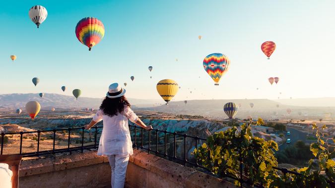 woman looking at hot air baloons.