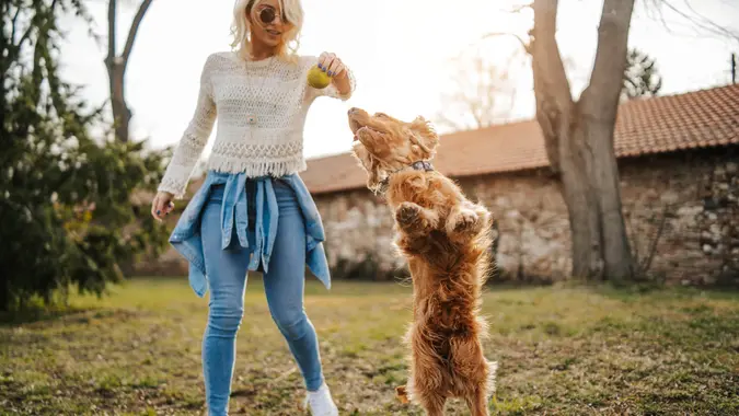 Young woman playing with her dog.