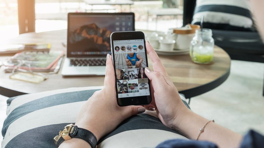 woman using instagram on mobile phone