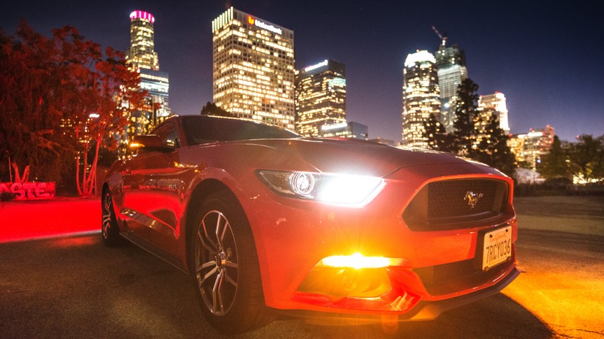 Los Angeles, California, USA - March 22, 2016: Front view of a red Ford Mustang GT car parked on the street against the Los Angeles city downtown.