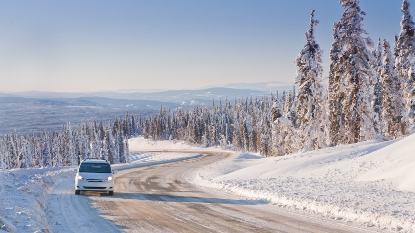 Car driving on an Icy Winter Road in Alaska’s Arctic Wilderness.