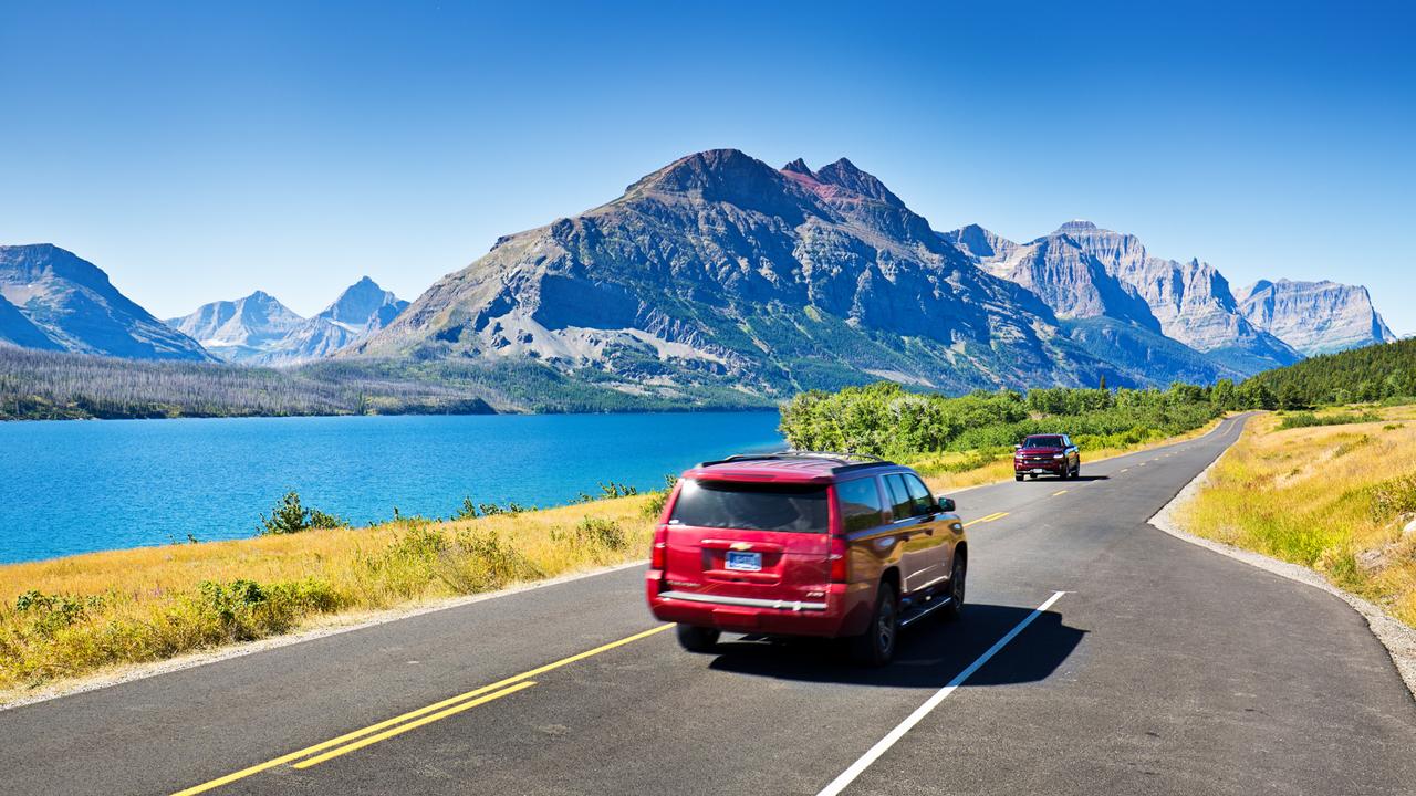 Glacier National Park, Montana, USA - August 4, 2016: Visitors to Glacier National Park touring the park along the breathtaking 'Going To The Sun Road' in cars or in park tour buses.