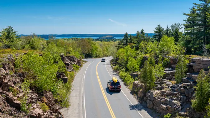 Cars driving on road in Acadia National Park, Maine, USA.
