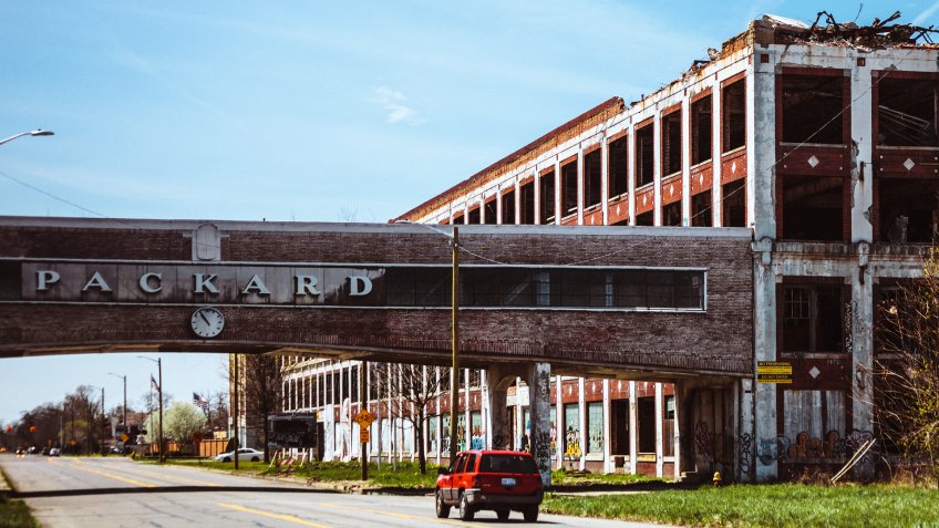Detroit, Michigan, USA- April 24, 2016: A car passing by the famous abandoned Packard plant in Detroit.