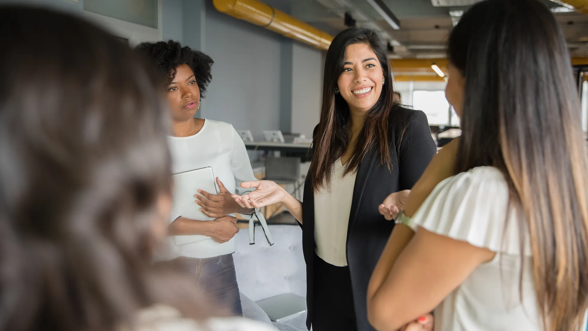 Businesswomen having informal conversation meeting in office.