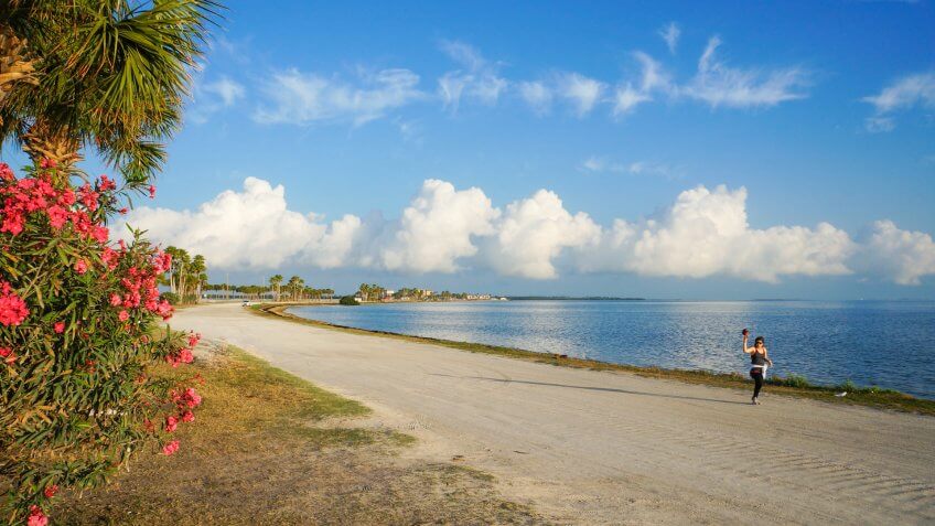 A woman jogging in the morning at Dunedin Causeway, Dunedin, Florida, April 23rd, 2017.