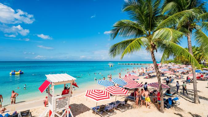 Doctor's Cave Beach in Montego Bay Jamaica People enjoy Doctor's Cave Beach, a famous, white, sandy beach in Montego Bay Jamaica on a sunny day.