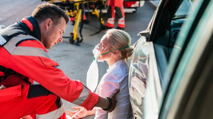Male Paramedic Helping Injured Woman.