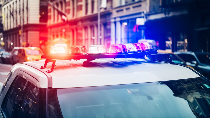 Police car with alarm and signal light flashes on the roof rush emergency call in New York City.