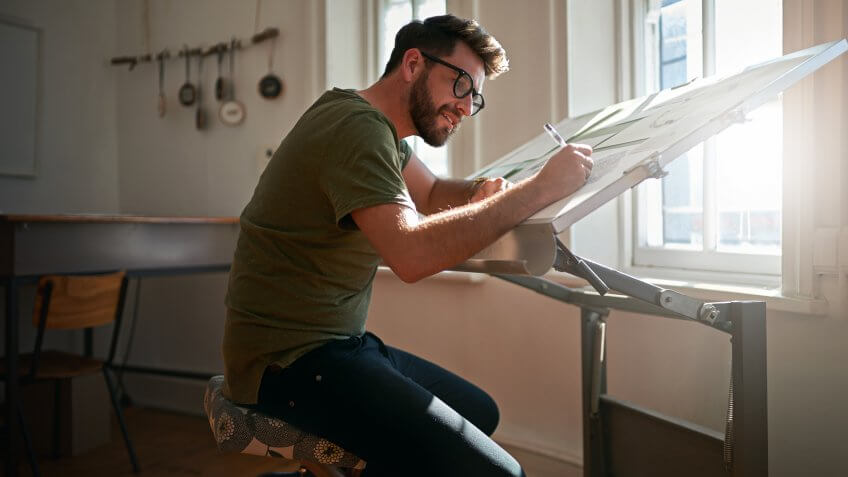 Shot of a young man working on a design at work.