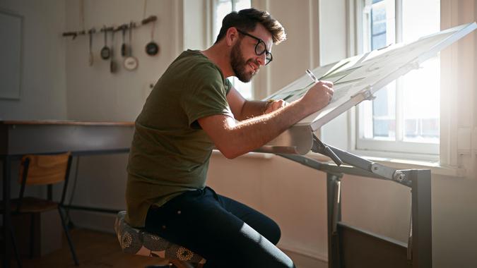 Creating eye catching designs Shot of a young man working on a design at work.