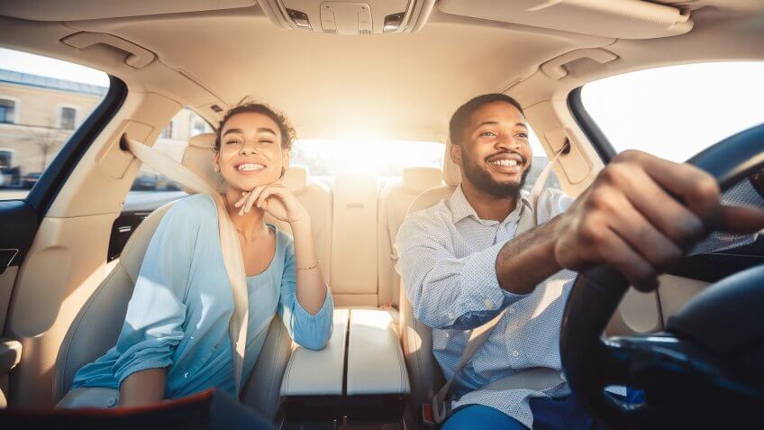 couple driving their new car