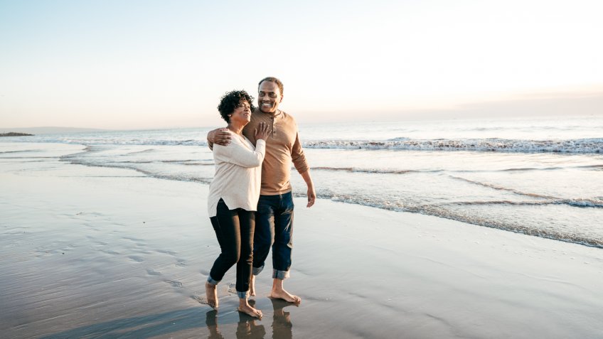 couple walking on the beach.