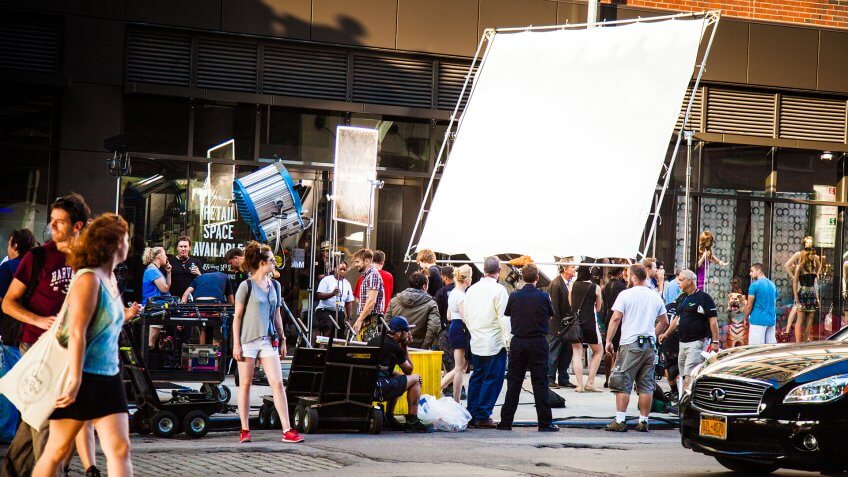New York City, New York, United States - August 21, 2014: Cameramen and crew setting up a shoot on street in Chelsea, New York for a movie set.