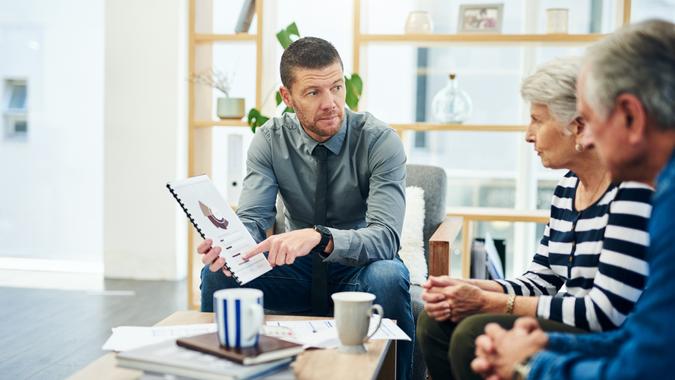 Shot of senior couple having a consultation with a financial advisor at home.