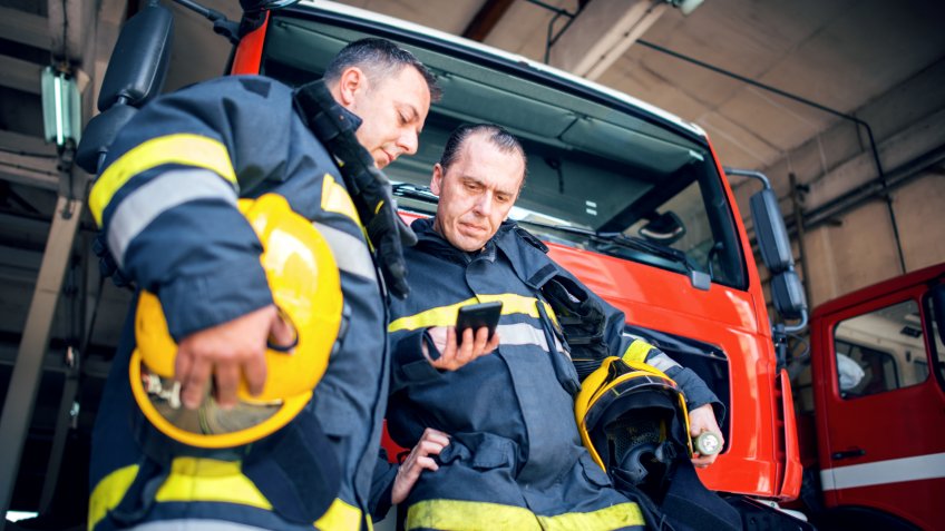 Firefighters using smart phone.