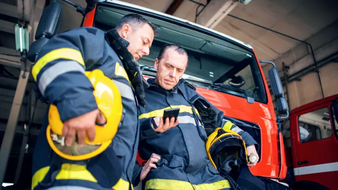 Firefighters using smart phone.