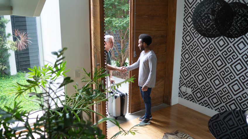 Host welcoming his guest in the entrance hall.