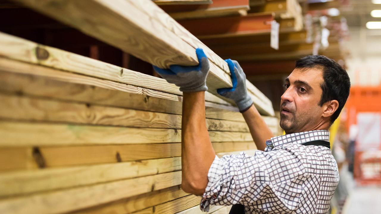 mature man Working at a timber/lumber warehouse.