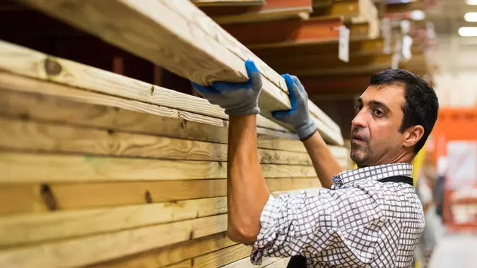 mature man Working at a timber/lumber warehouse.