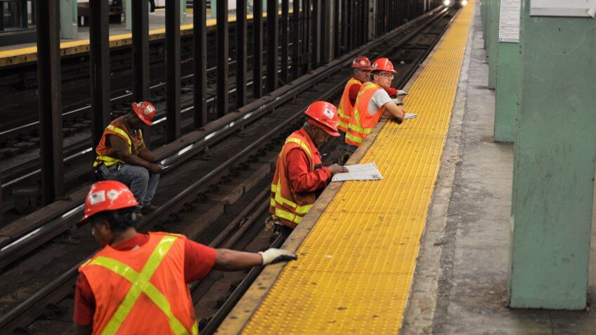Forest Hills, NY/ USA: 9-12-18- New York Subway MTA Worker Repairing and Working on Train Tracks Service Renovation.