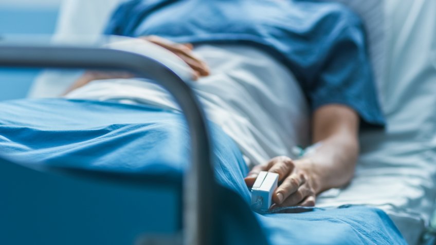 In the Hospital Sick Male Patient Sleeps on the Bed.
